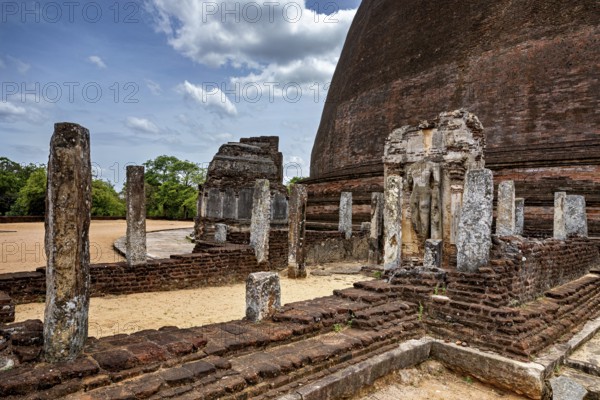 Architectural details and ruins of an ancient site next to a large stupa, The Temples of Polonnaruwa in Sri Lanka