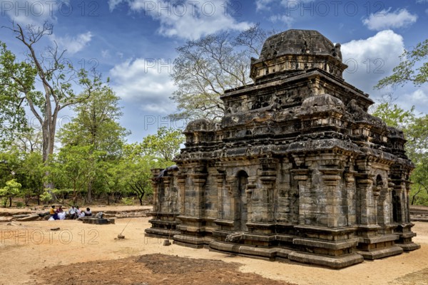 Ancient stone building amidst a ruined landscape with sky and trees, The temples of Polonnaruwa in Sri Lanka