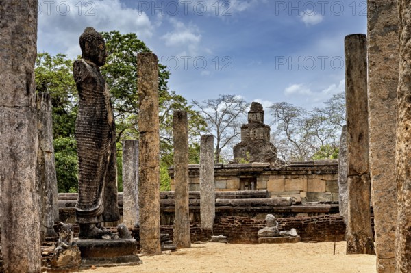 Ancient stone statue and pillars surrounded by ruins and an open landscape, The temples of Polonnaruwa in Sri Lanka