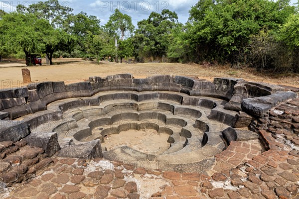 Stone-shaped concentric water basin in ancient style surrounded by trees, The temples of Polonnaruwa in Sri Lanka