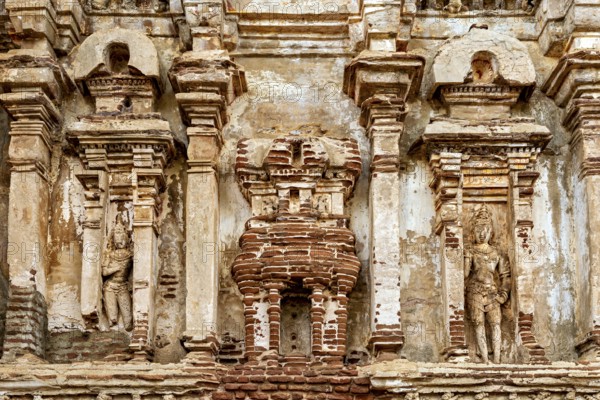 Detailed view of an ancient wall with stone reliefs and weathered surface, The temples of Polonnaruwa in Sri Lanka