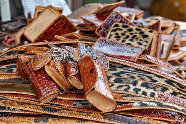 Market with brown leather accessories and eye-catching leopard patterns, leather products from poaching in the Amazon jungle near Rurrenabaque in Bolivia