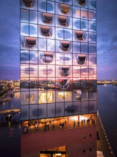 Aerial view of the Elbe Philharmonic Hall with reflections on the façade in the evening light above the harbor, Hamburg, Germany