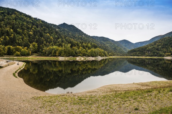 Picturesque mountain lake with water reflections in autumn, Lac de Kruth-Wildenstein, Kruth, Vosges, Alsace-Lorraine, Department of Vosges Haut-Rhin, France