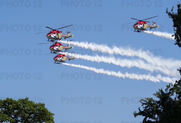 Indian Air Force (IAF) ALH Mk1 Sarang helicopters soar through the sky during an air show as part of the 93rd Air Force Day celebrations on November 8, 2025 in Guwahati, India