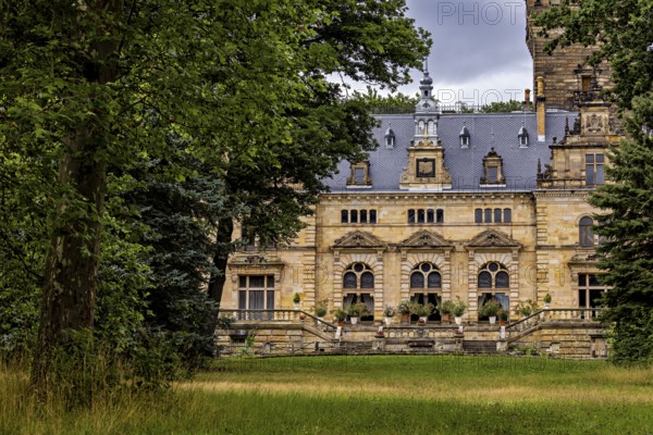 Historic castle surrounded by lush nature and cloudy skies, The Hummelshain hunting lodge in Thuringia