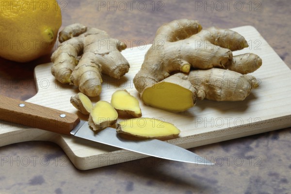 Ginger, ginger root cut with ginger slices on wooden boards