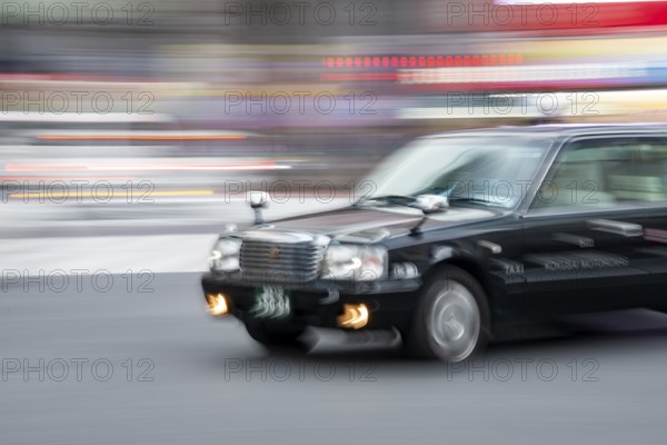 Black taxi driving, motion blur, long exposure, Shubuya Crossing, Shibuya, Tokyo, Japan
