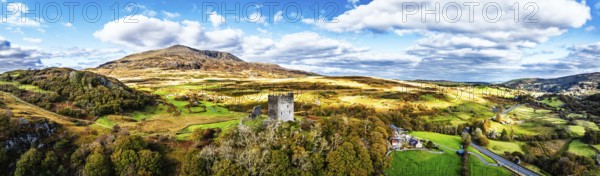 Autumn colours over Castell Dolwyddelan and Eryri Mountains from a drone, Snowdonia, Conwy County Borough, Wales, England, United Kingdom