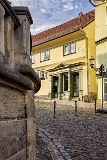 Yellow historic building on a paved street with classic architecture, The old town of Arnstadt in Thuringia