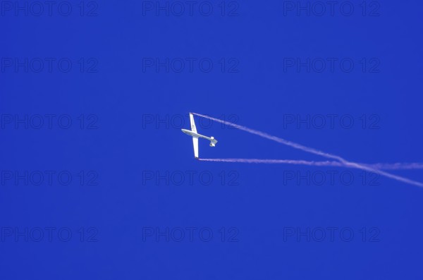 An SZD-59-1 ACRO glider, registration D-1138, during a demonstration as part of an air show at the Fliegerbergfest of the Rossfeld Luftsportverein in Metzingen-Glems, Baden-Württemberg, Germany, for editorial use only