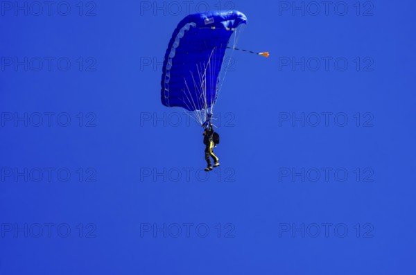 Skydivers during an aerial acrobatic performance as part of an air show at the Fliegerbergfest of the Rossfeld Luftsportverein in Metzingen-Glems, Baden-Württemberg, Germany, for editorial use only