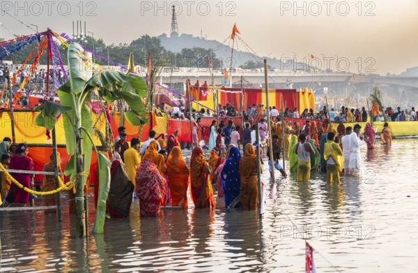 Hindu devotees gather on the banks of the Brahmaputra River to offer prayers to the Sun God on the occasion of Chhath Puja, in Guwahati, India on 27 October 2025
