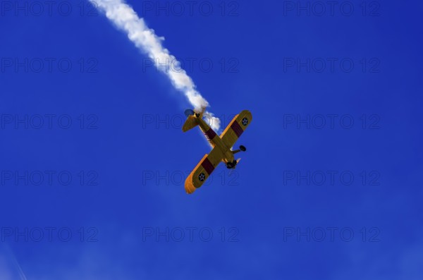 A Boeing PT-17 Stearman biplane, also Boeing Stearman Model 75, with the inscription 399 USNAVY N67193 during a flight demonstration as part of an air show on Rossfeld in Metzingen-Glems, Baden-Württemberg, Germany, for editorial use only