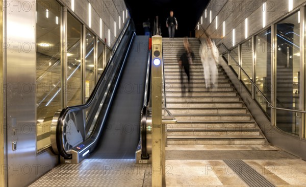 Night photo, long exposure with motion blur, modern underground entrance at Unter den Linden station, contemporary design with stairs and escalator, Berlin, Germany