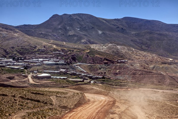 Village on the slope of a mountain in the middle of a dry hilly landscape, The landscape of the Altiplano in Bolivia