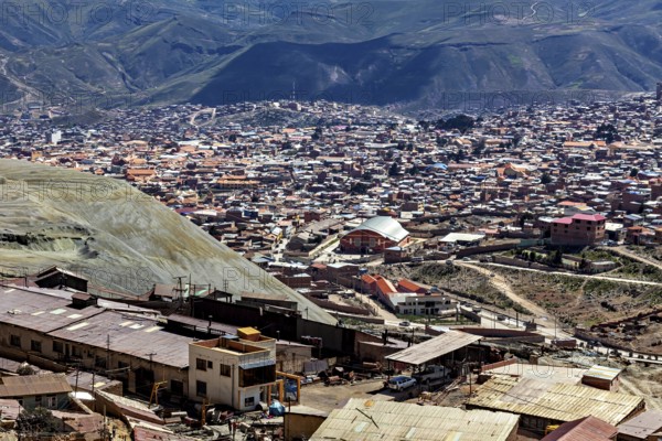 View of a densely populated city in a mountainous landscape with many houses and hills in the background, view over the silver city of Potosi in Bolivia