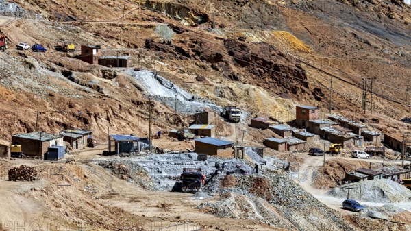 Spacious settlement with huts and vehicles in a barren, stony terrain, The silver mines of Potosi Bolivia