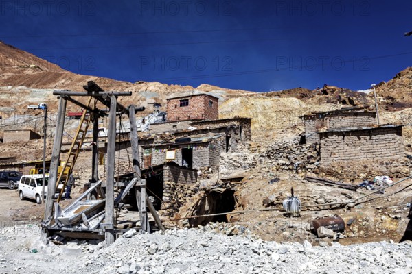 Weathered stone houses and huts on a mountainside with a clear sky, The silver mines of Potosi Bolivia