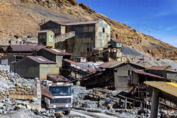 Old industrial complex with a lorry in a mountainous environment under a clear blue sky, The silver mines of Potosi Bolivia