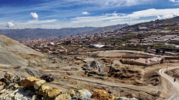 View of a town along a mountainous landscape under a clear blue sky with few clouds, The silver mines of Potosi Bolivia