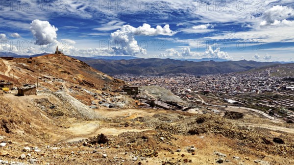 Dry mountain landscape with views of a town and an impressive sky full of clouds, view from Silver Mountain Cerro Rico to Potosi in Bolivia