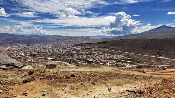 Large cityscape between hills under a dramatically cloudy sky with a wide view, view from Silver MountainCerro Rico to Potosi in Bolivia