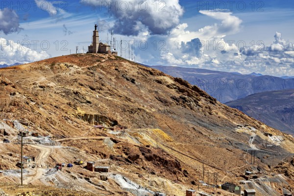 Single building with antennas on a bare hill under a dramatic sky, The silver mines of the Cerro Rico silver mountain near Potosi in Bolivia