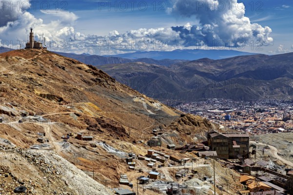 Sweeping views over a city in the middle of a mountain landscape under dramatic clouds, The silver mines of the Cerro Rico silver mountain near Potosi in Bolivia