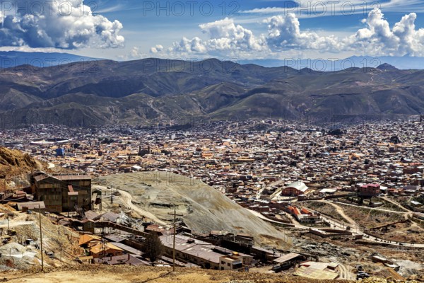 City view with surrounding mountains and numerous buildings under a cloudy sky, The silver mines of the Cerro Rico silver mountain near Potosi in Bolivia