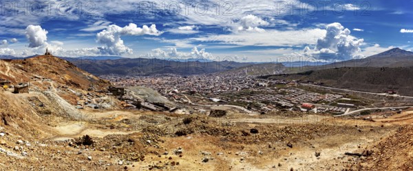 Panoramic view of a vast landscape with mountains and a city under a cloudy sky, view from Silver MountainCerro Rico to Potosi in Bolivia