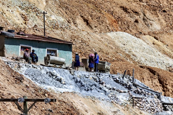 Miners with wheelbarrows on a rocky slope during mining work, The silver mines of Potosi Bolivia