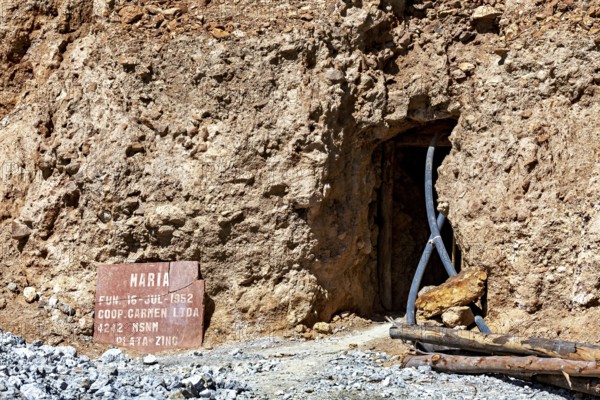 Mine entrance with shield and metallic beams in a rocky environment, The silver mines of Potosi Bolivia
