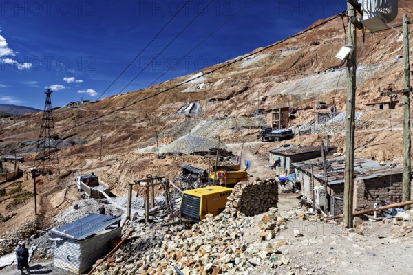Huts and cable poles on the mountainside with an intense blue sky in the background, The silver mines of Potosi Bolivia