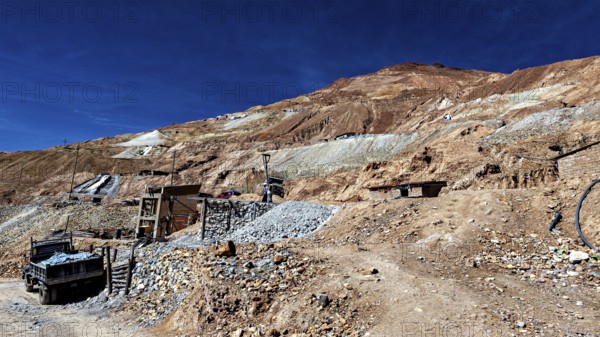 Stony landscape with an old lorry on an unpaved road, The silver mines of Potosi Bolivia