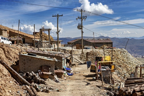 Mountain village with huts, racks and power lines under a clear sky, The silver mines of Potosi Bolivia