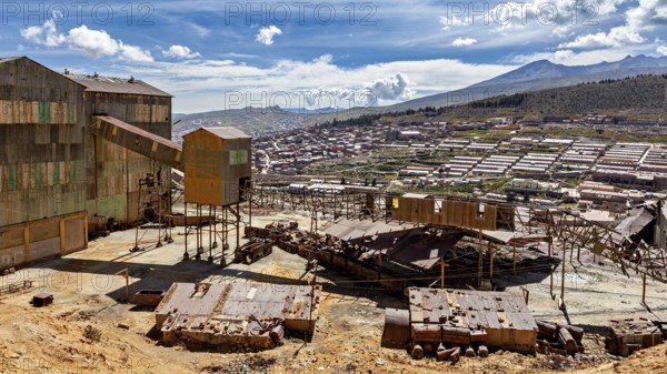 Industrial building in the foreground with sweeping views over a valley and mountains, The silver mines of Potosi Bolivia