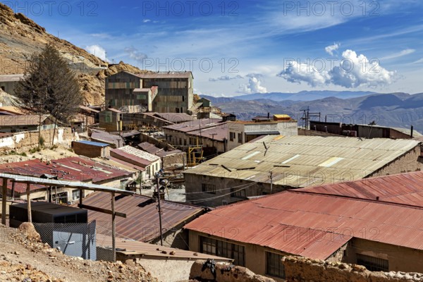 View of roofs and abandoned mine buildings with hills in the background, The silver mines of Potosi Bolivia