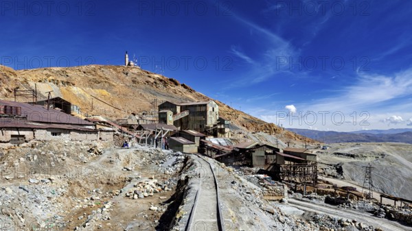 Abandoned mining infrastructure on a hill with a dramatic sky, The silver mines of Potosi Bolivia