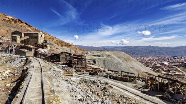 View of abandoned mine buildings and railway tracks in a hilly landscape, The silver mines of Potosi Bolivia