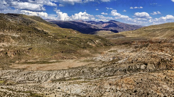 Wide valley in a mountainous region with sparse vegetation, The landscape of the Altiplano in Bolivia