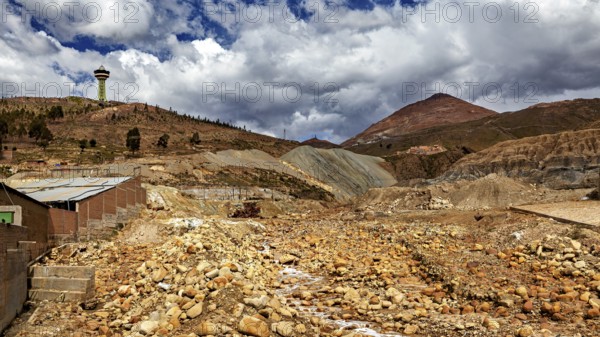 Wide, dry landscape with hills, cloudy skies and a radio tower, The landscape near Potosi in Bolivia