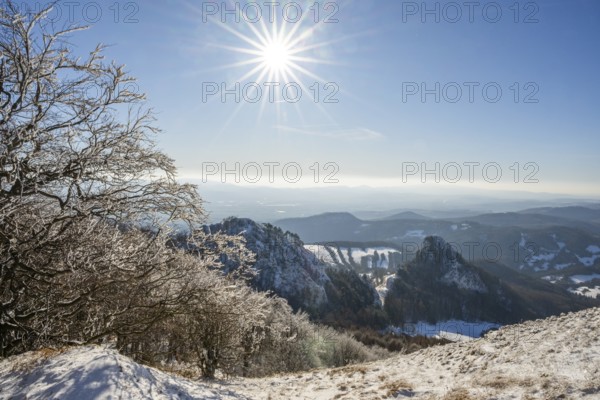 View over the hills and valleys from the mountain with hoarfrost on the branches in winter, Vápec, Horná Poruba, Slovakia