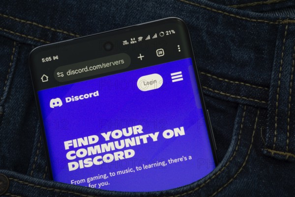 Dhaka, Bangladesh- 03 Oct 2025: A smartphone displaying the Discord web interface peeks out of a denim pocket