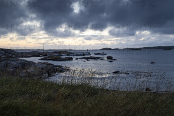 Small bay, archipelago, jetty with angler, Resö Island, Bohuslän, Skagerrak, Sotenäs, Västra Götalands län, Sweden