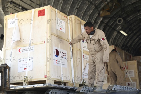 Members of the Qatari Air Force unload humanitarian aid supplies from a transport aircraft at Damascus International Airport as part of Qatar's air and land relief bridge to Syria, Damascus, Damascus, Syria
