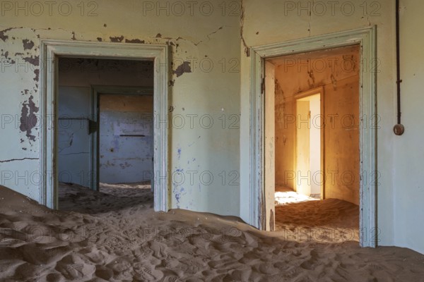 At Kolmanskop, the abandoned ghost town of the diamond days of the early 1900 and of German origin. Inside the restricted Diamond Area east of the coastal town of Lüderitz. Namib Desert, Namibia