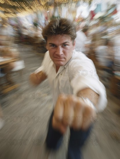 A man gets into a fighting stance, surrounded by dynamic movement and a background filled with lights, symbolic image for physical confrontation in public, use of force, physical violence, act of violence, aggressive behaviour, brawl, AI generated