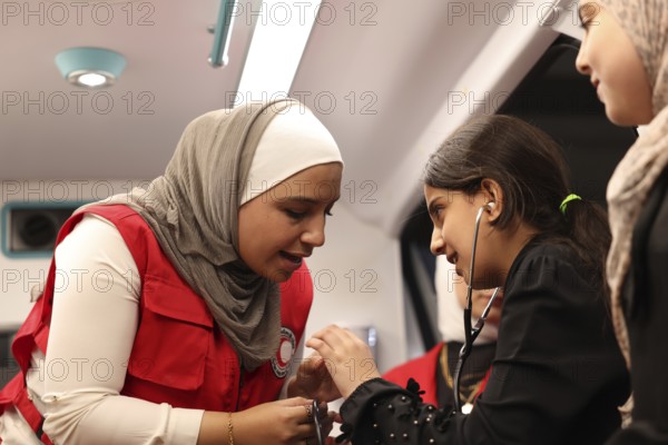 Syrian Arab Red Crescent volunteers conduct first aid training for children during the Damascus International Fair, the first edition held after the fall of Bashar al-Assad. The activity raises awareness of health, safety, and emergency preparedness among young visitors, Damascus, Damascus, Syria
