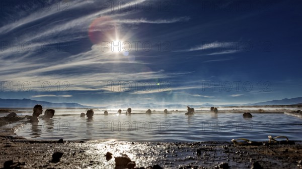 Sunrays over people in hot springs, surrounded by nature, The thermal springs of Polques in Bolivia